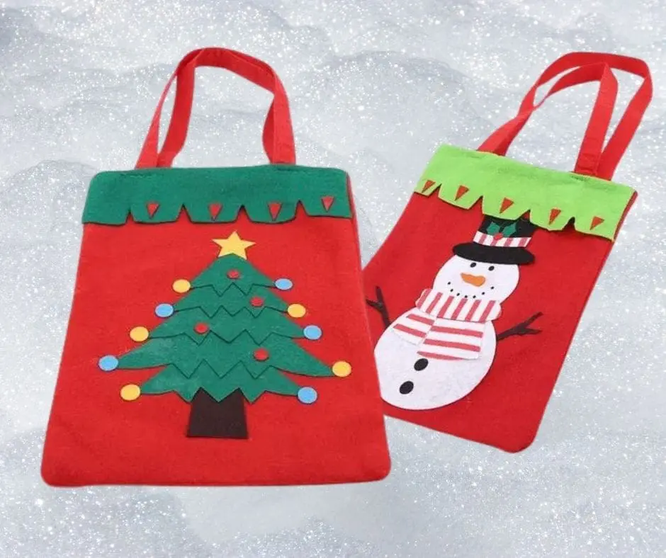 Two bags of christmas decorations are sitting in the snow.