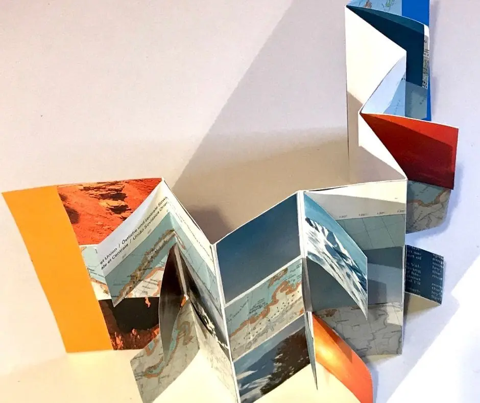 A close up of several folded books on top of each other.