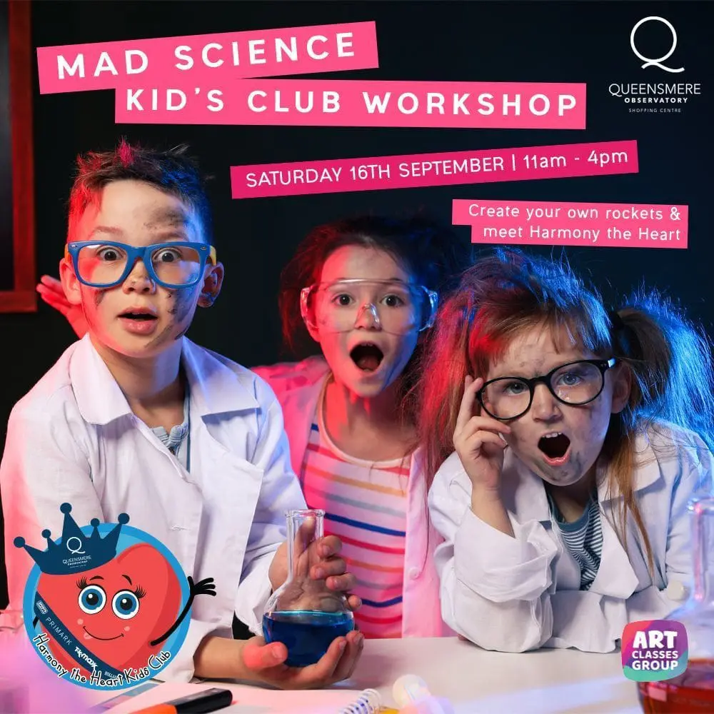 A group of kids sitting in front of a pink wall.