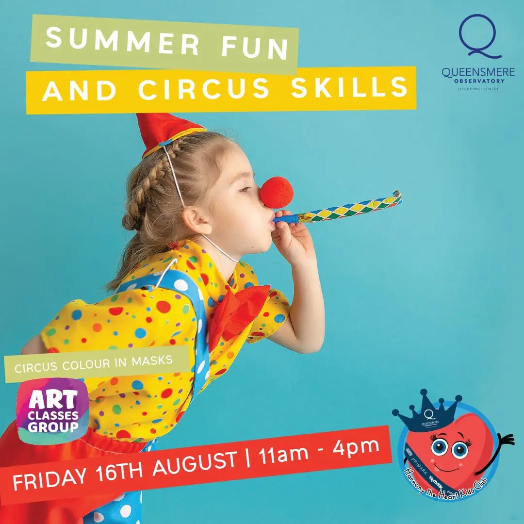 Girl in clown costume blowing party blower.