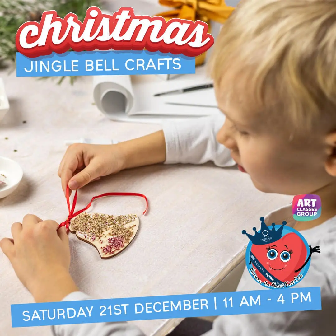 Child making Christmas jingle bell crafts.