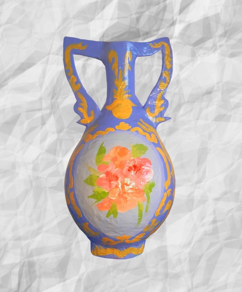 A blue vase with flowers painted on it.