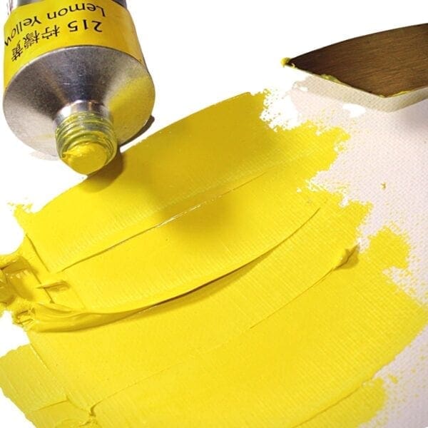 A yellow paint brush and some yellow paper