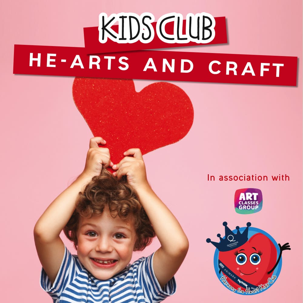A boy holding up a heart with the words " kids club he-arts and craft ".